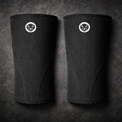 Front view of a pair of Mammal Strength Stiff Knee Sleeves PRO featuring ultra-stiff black CR neoprene and Mammal Strength logo
