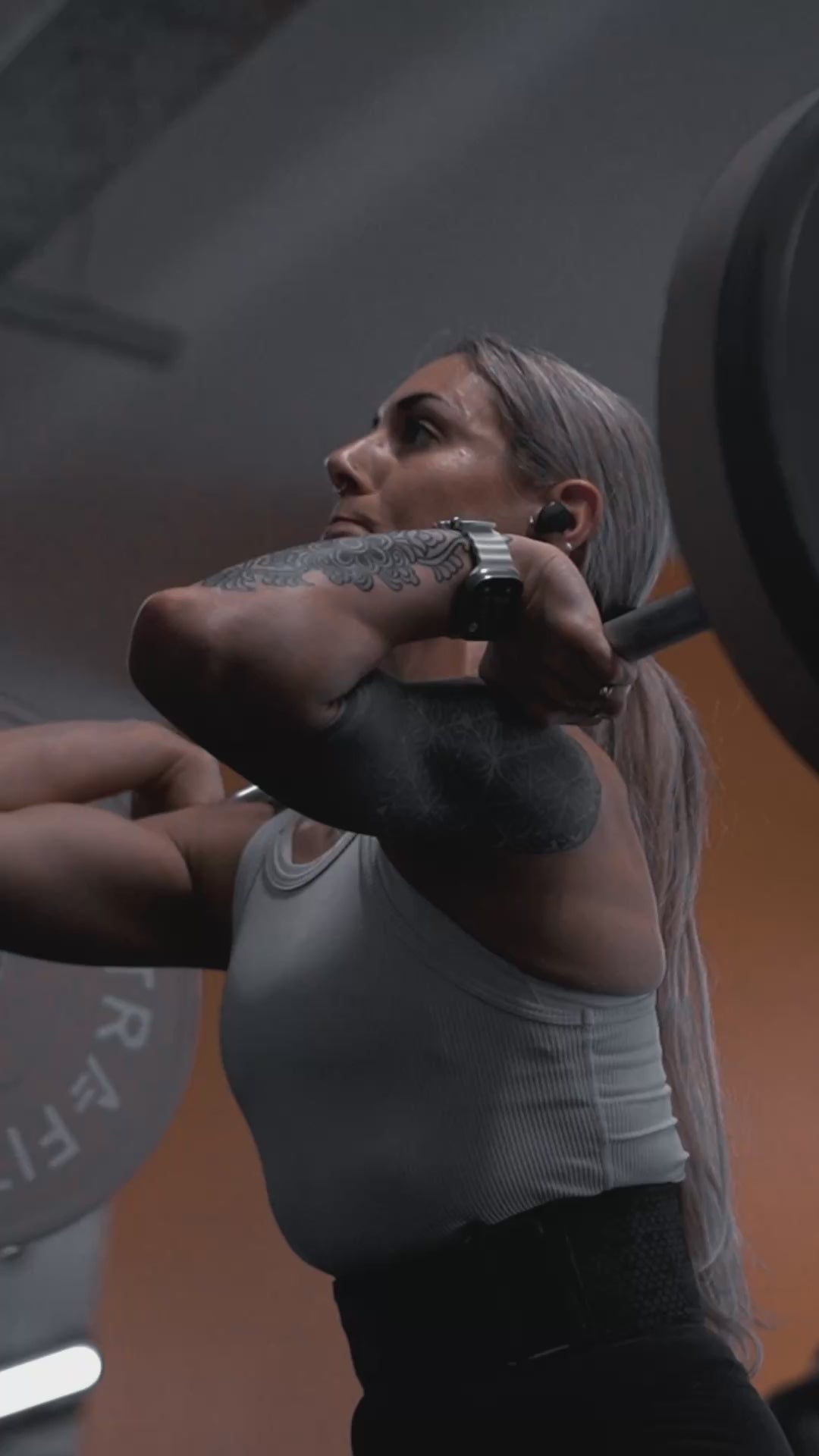 Athlete wearing Mammal Strength V3 knee sleeves performing a deep squat during real gym training